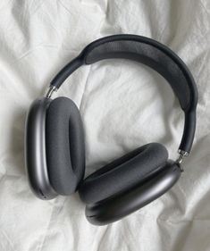 headphones laying on top of a white sheet