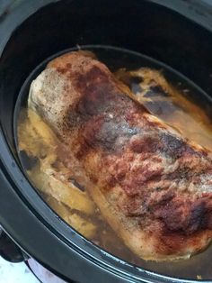 a piece of meat is cooking in the slow cooker