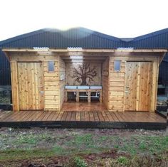 a small wooden structure with benches on the outside