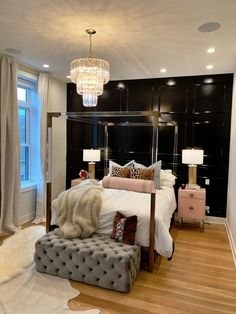 a bedroom with a large bed and chandelier