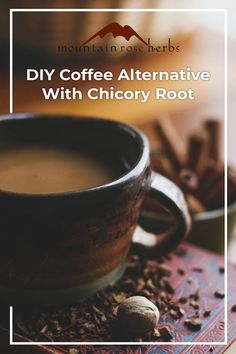 a cup of coffee sitting on top of a table next to cinnamons and spices