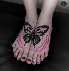 a woman's feet with pink and black butterfly tattoos on their toes, while the bottom part of her foot is shown