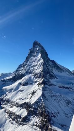 a very tall mountain with snow on it's sides in the middle of winter