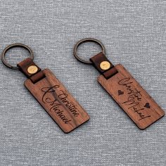 two wooden keychains with the words, happy father's day written on them