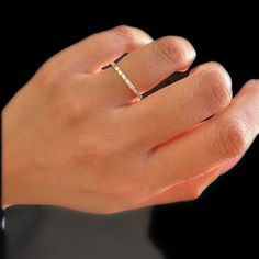 a woman's hand with a diamond ring on it