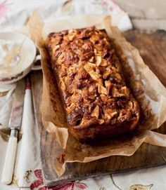 a loaf of bread sitting on top of a wooden cutting board