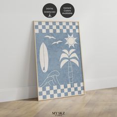 a blue and white poster sitting on top of a wooden floor next to a wall