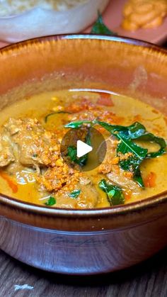 a bowl filled with soup on top of a wooden table