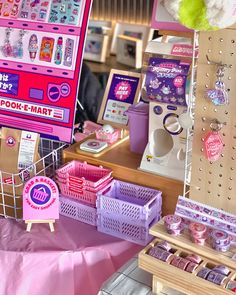 there are many toys on display in the store, including pink and purple items for sale