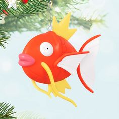 a red fish ornament hanging from a christmas tree