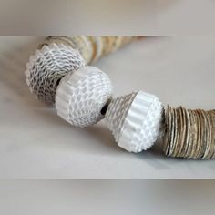 several rolls of paper are stacked on top of each other in order to make a necklace