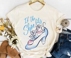 a t - shirt that says if the cats shoe is on it, next to some flowers