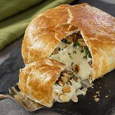 a piece of bread with cheese and spinach in it