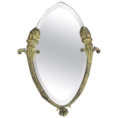 an ornately decorated mirror is shown against a white background