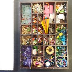 a box filled with lots of different types of crafting supplies in it's compartments