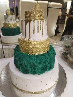 three tiered wedding cake with gold and green icing