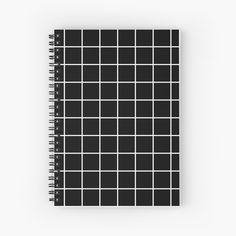 a spiral notebook with black and white squares