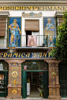 an old building with colorful tiles on it