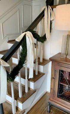 a set of stairs decorated with christmas wreaths