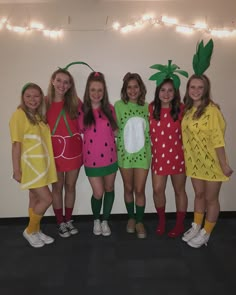 four girls in fruit costumes posing for the camera