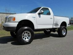 a white pick up truck parked in a parking lot