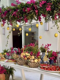 a table topped with lots of fruit and flowers