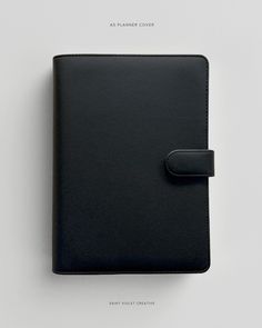 a black notebook with a leather cover