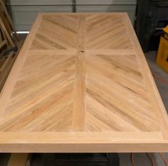 a square wooden table sitting on top of a hard wood floor