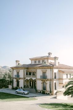 a car parked in front of a large house