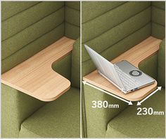 a laptop computer sitting on top of a wooden table next to a green couch with measurements