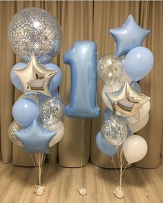 blue and silver balloons are arranged in the shape of numbers