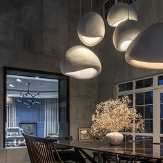 an elegant dining room with modern lighting fixtures