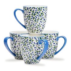 four blue and white coffee cups stacked on top of each other