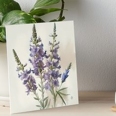 a painting of purple flowers on a white background art boarder next to a potted plant