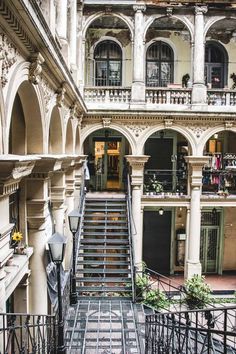 an old building with stairs leading up to the second floor