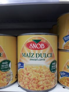 several cans of macaroni and cheese are on the shelf