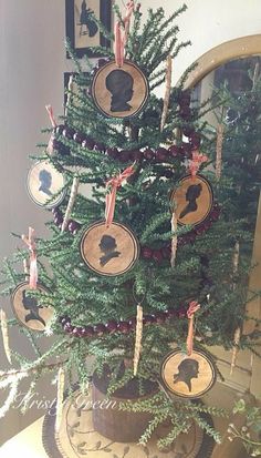 a christmas tree decorated with silhouettes and ribbons