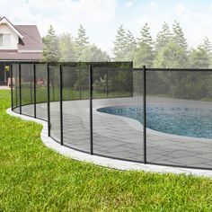 a fenced in pool surrounded by green grass