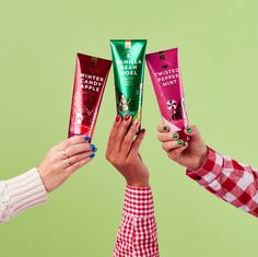 three women holding up different types of hand creams