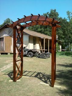 an image of a wooden arbor in front of a house with the word pin it on it