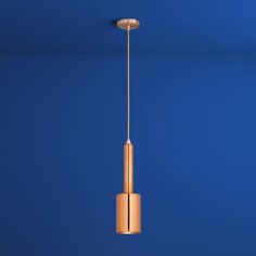 a light fixture hanging from the ceiling in a blue room