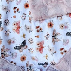 a blanket with flowers and butterflies on it