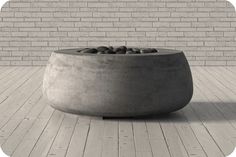 a concrete bowl sitting on top of a wooden floor