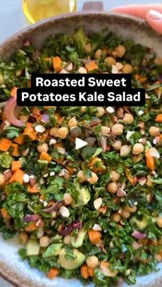 roasted sweet potatoes kale salad with chickpeas and carrots in a bowl