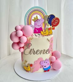 a peppa pig themed cake with balloons and decorations