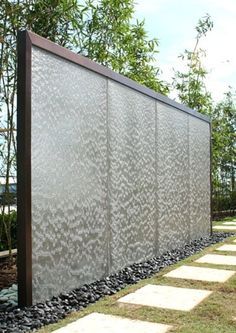 an outdoor privacy wall in the middle of a park