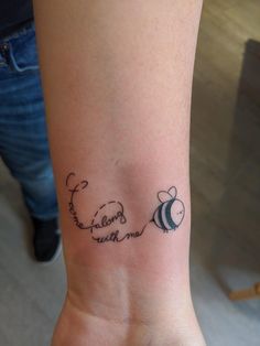 a woman's wrist with a tattoo saying, i love you to the moon and back