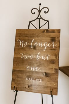 a wooden sign that says no longer two but one mark 10 6 on the front