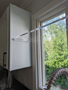 a white refrigerator freezer sitting in the corner of a kitchen next to a window