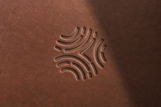 a close up of a brown leather surface with a design on the bottom and side